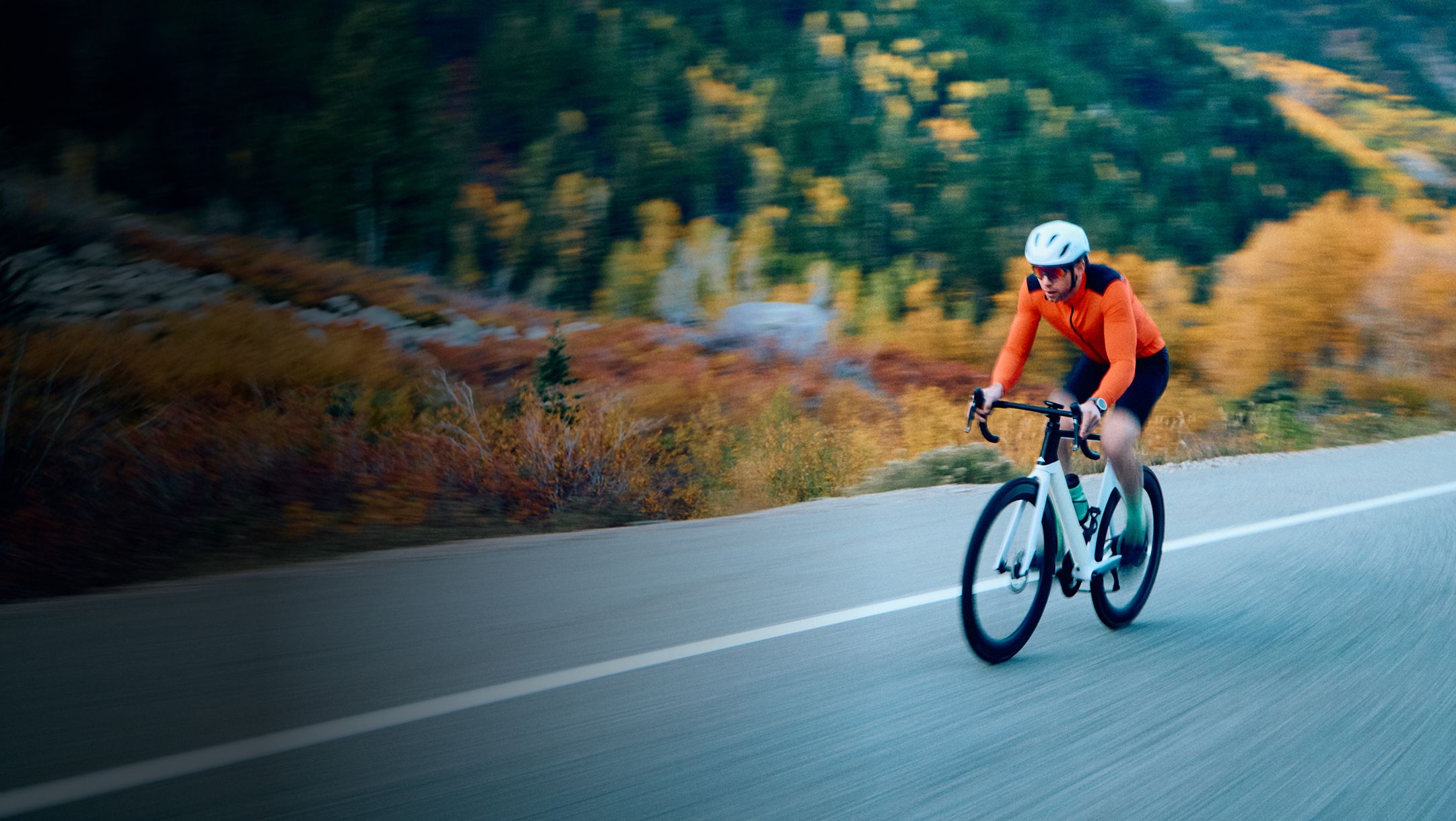 Cyclist riding uphill road symbolizing resilience and discipline