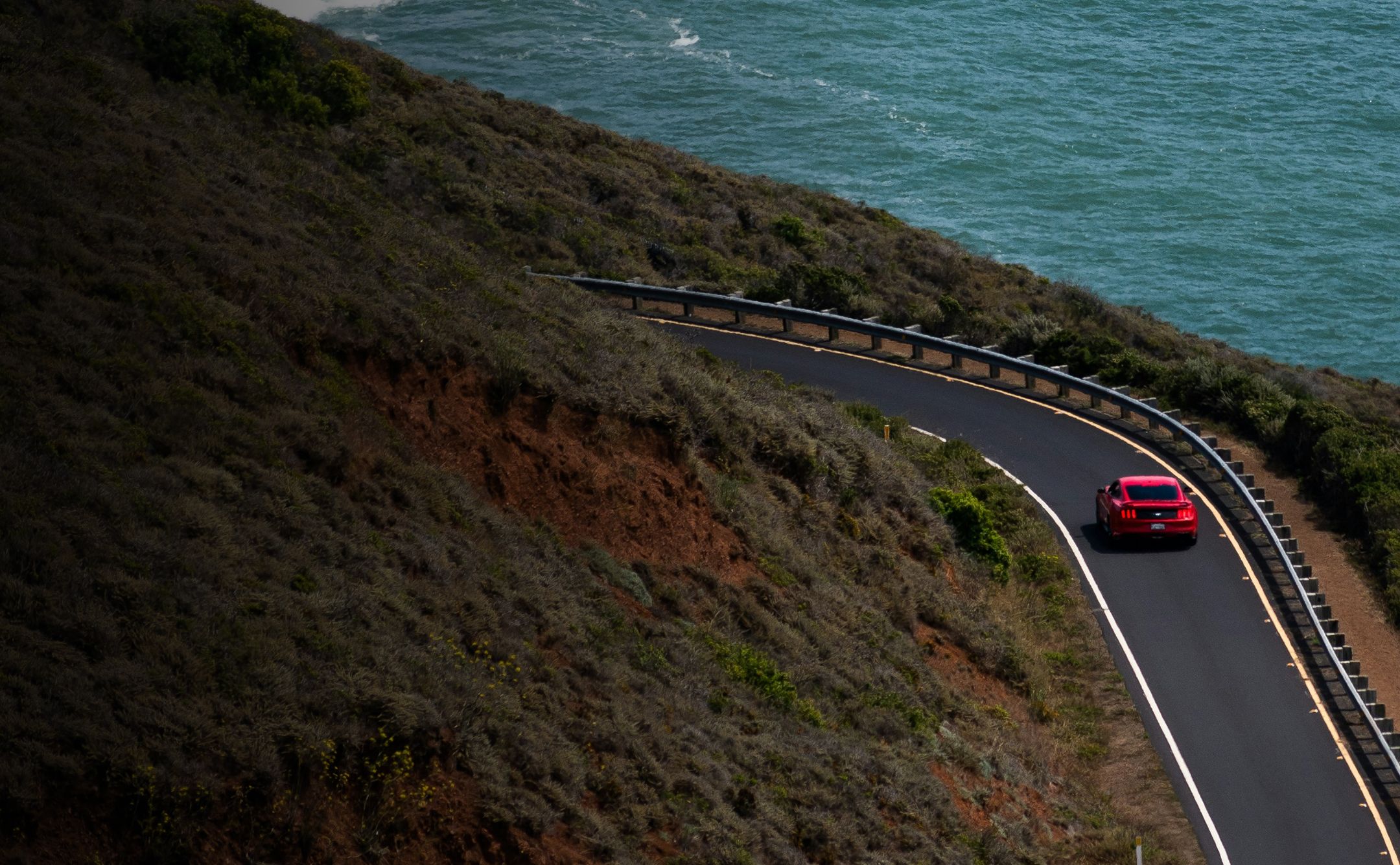 Scenic coatal highway with sports car highlighting deserving the right investment strategy
