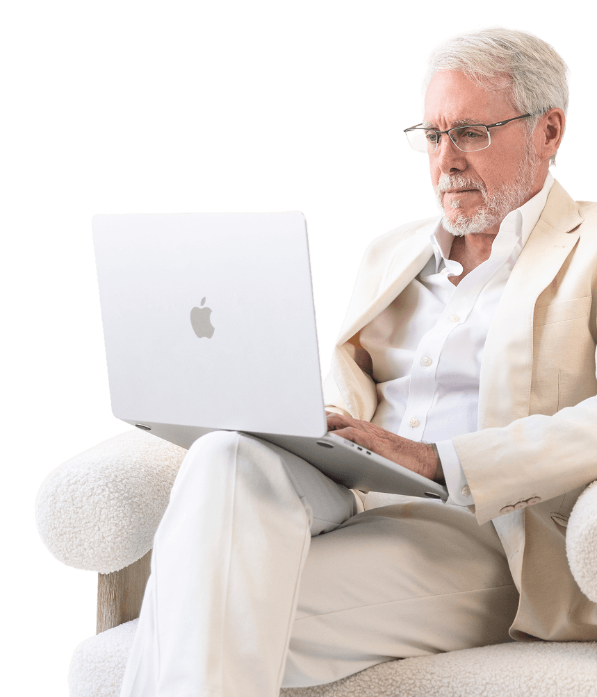 Bill Harris in a suit using a laptop
